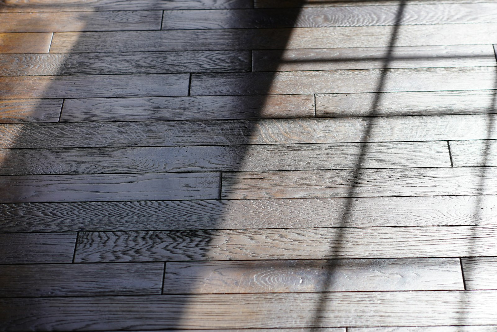 Sunlit room with wide-plank wood floor
